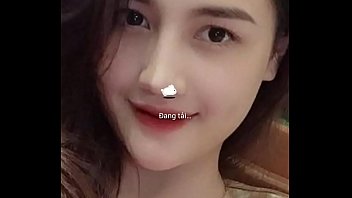 A bespectacled Vietnamese woman wriggles naked in front of the webcam