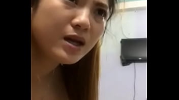 A single Vietnamese woman rubs her pussy with a cucumber